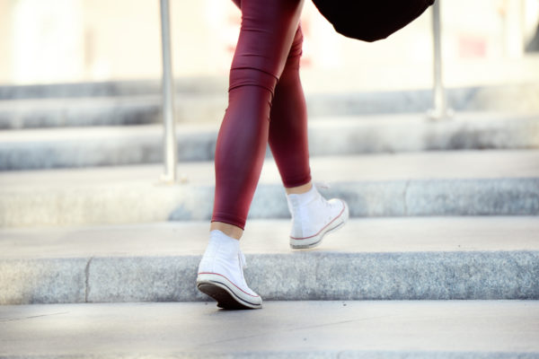 Close up of woman walking up stairs