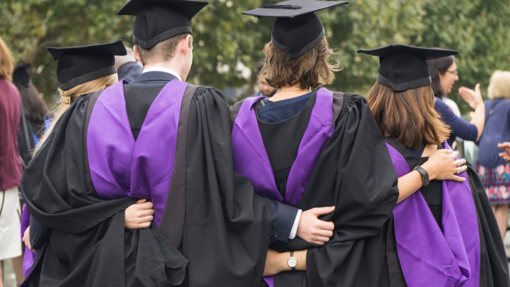 Students at graduation wearing caps and gowns