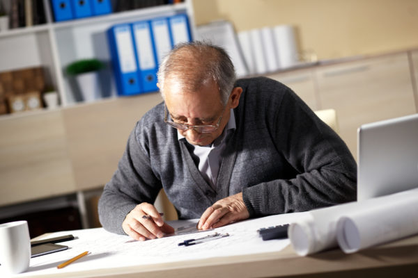 An older person working at a desk