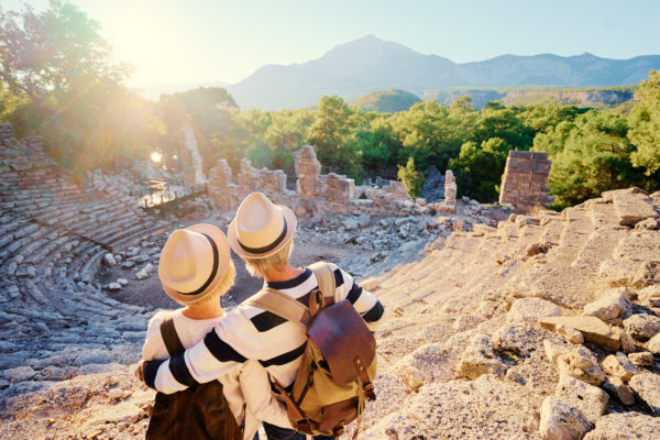 A mature couple enjoying the view of an ancient amphitheatre.