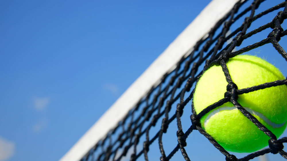 Tennis ball hitting net