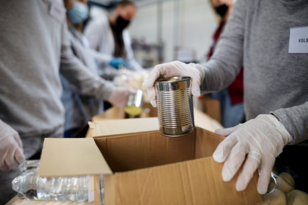 People packing a food bank parcel.