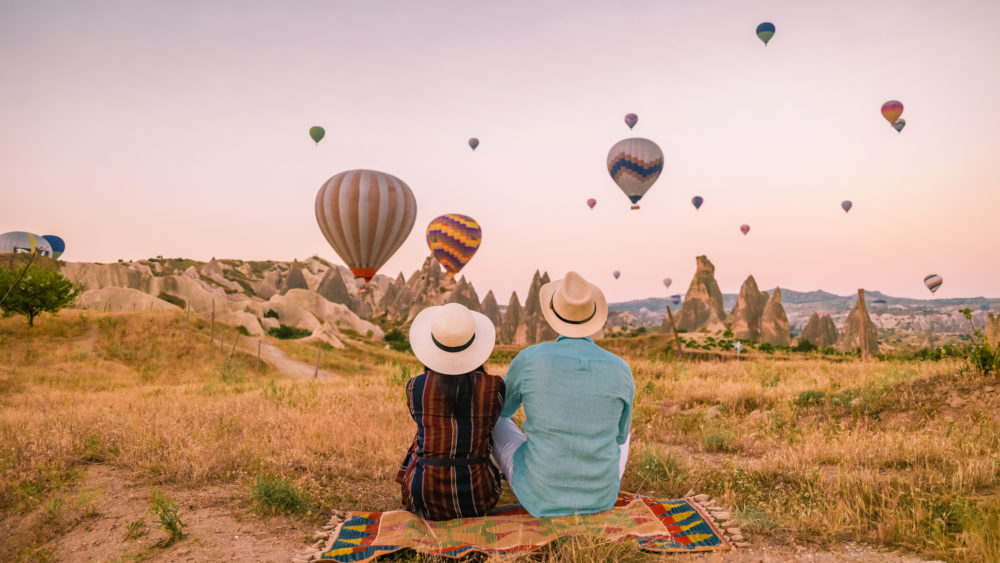 A couple watching hot air balloons in Turkey.
