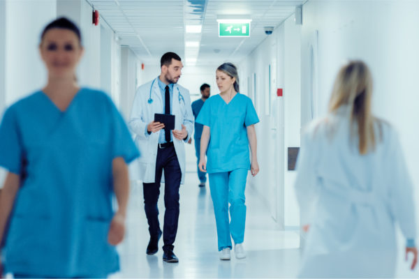 Doctors walking down a hospital corridor.