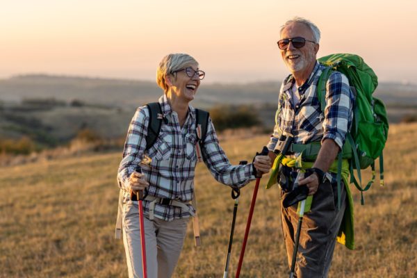 A retired couple hiking.