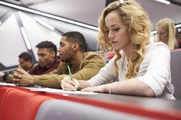 A group of students in a university lecture hall.