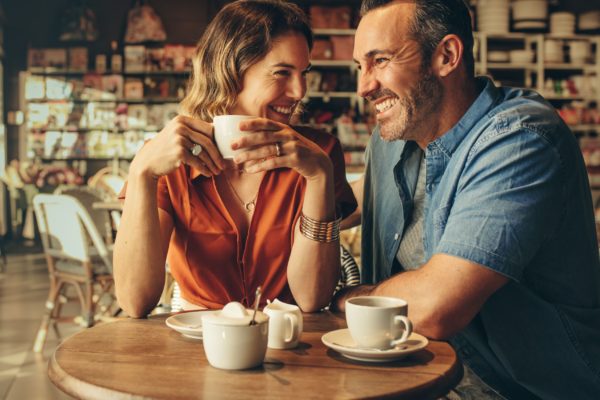 A couple laughing in a café.