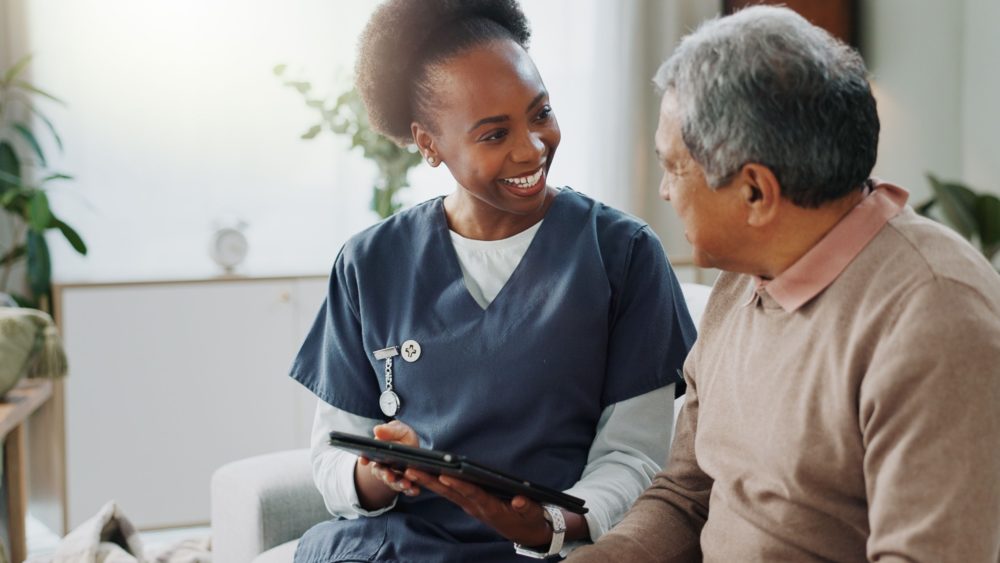 A care worker visiting a man in his home.