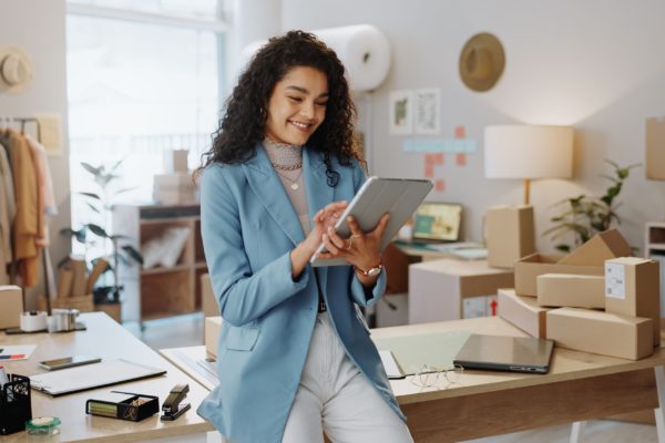 A female business owner using a tablet in an office.