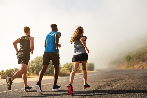 Three people running outdoors.