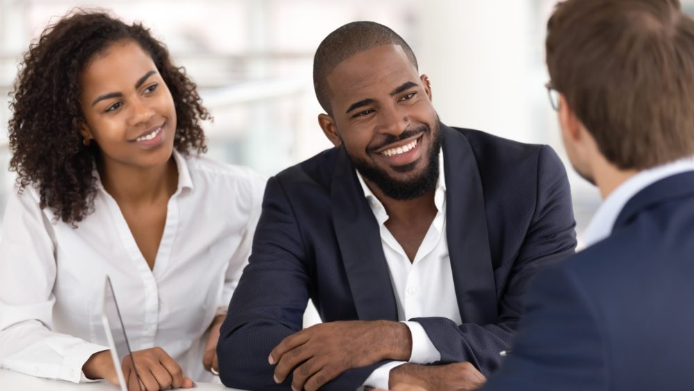 A couple taking to a financial planner.