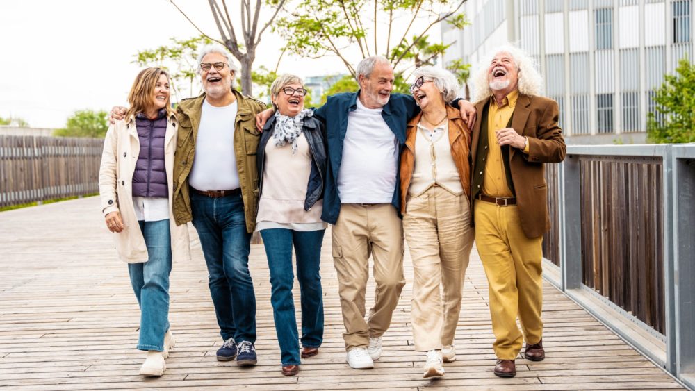 A group of people walking together and laughing.