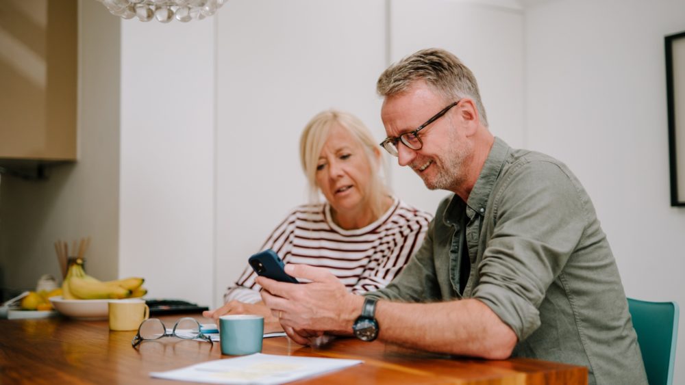 A couple going through paperwork together.