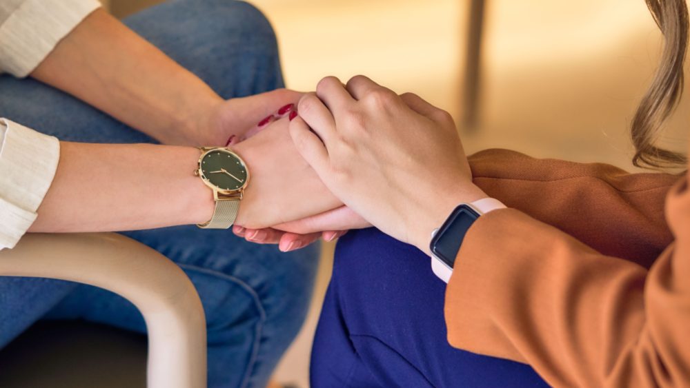 Two people clasping hands.