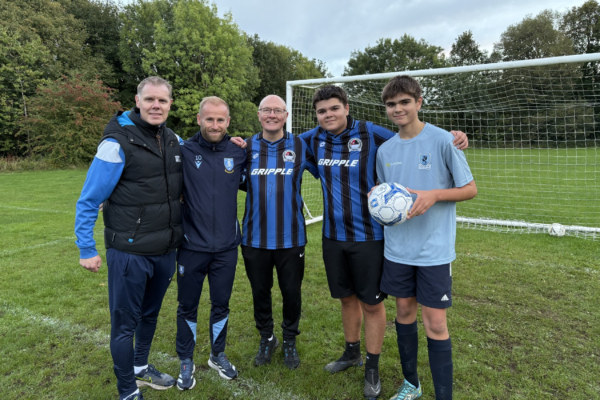 Some of the team stood together in front of the goal